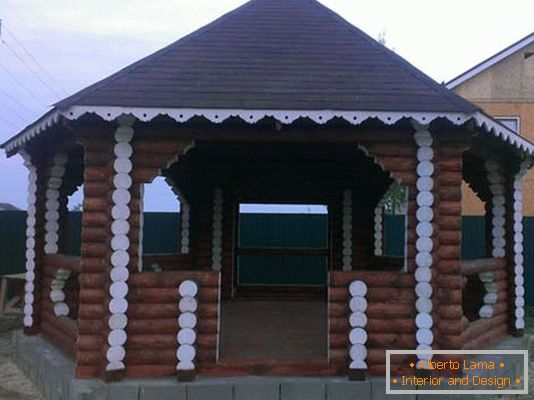 La struttura della casa di tronchi è un'opzione classica per decorare il cortile di una villa di campagna.