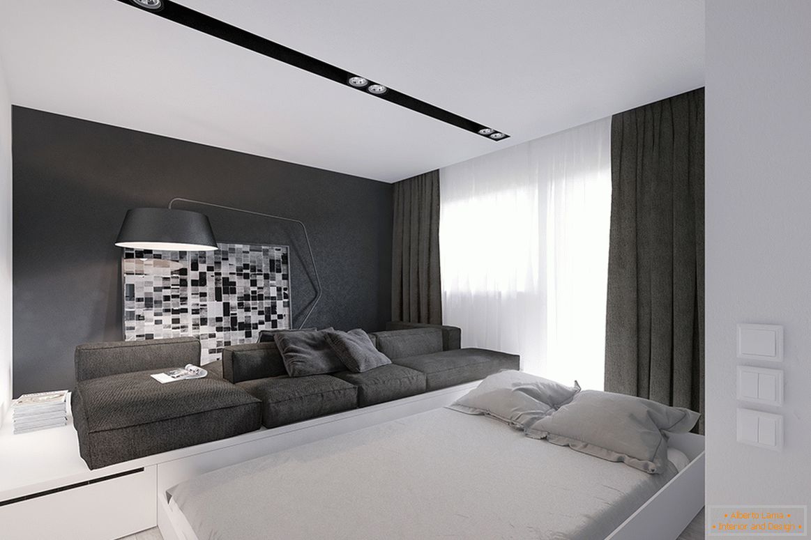 Un letto estraibile nel soggiorno di un piccolo appartamento