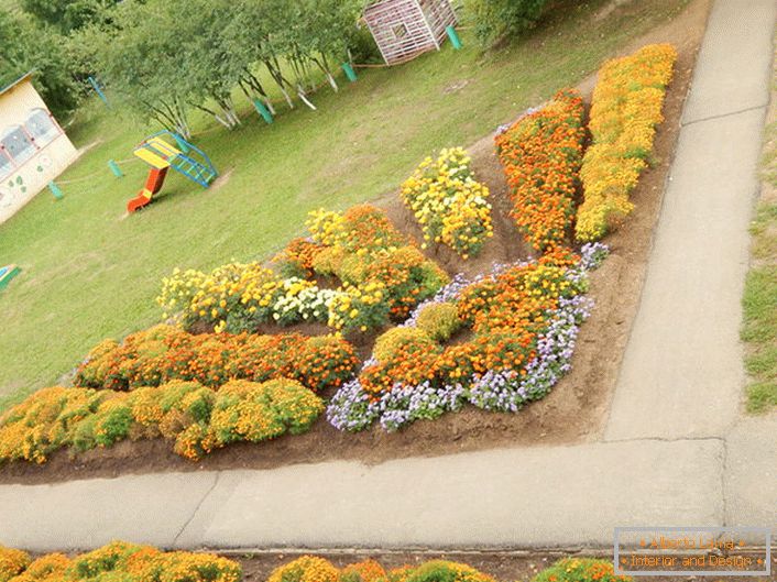 Il giardino fiorito modulare sotto forma di un sole radioso appare armoniosamente nel parco giochi.