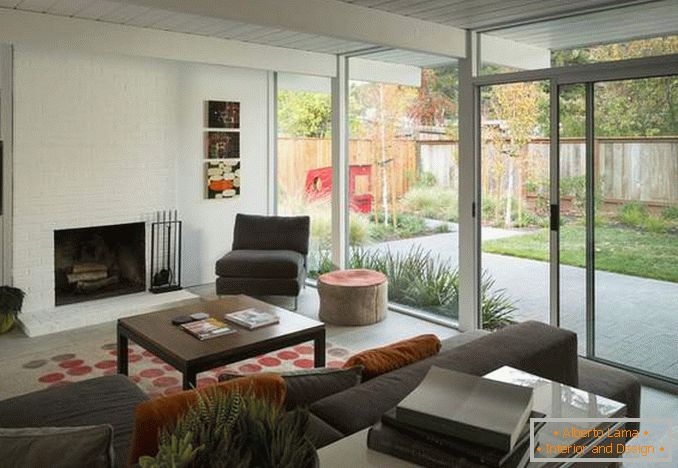 Design di un soggiorno con una finestra panoramica - una foto all'interno di una casa privata