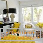 Camera da letto bianca con decorazioni gialle